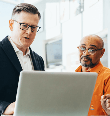 Stock photo of people using a laptop